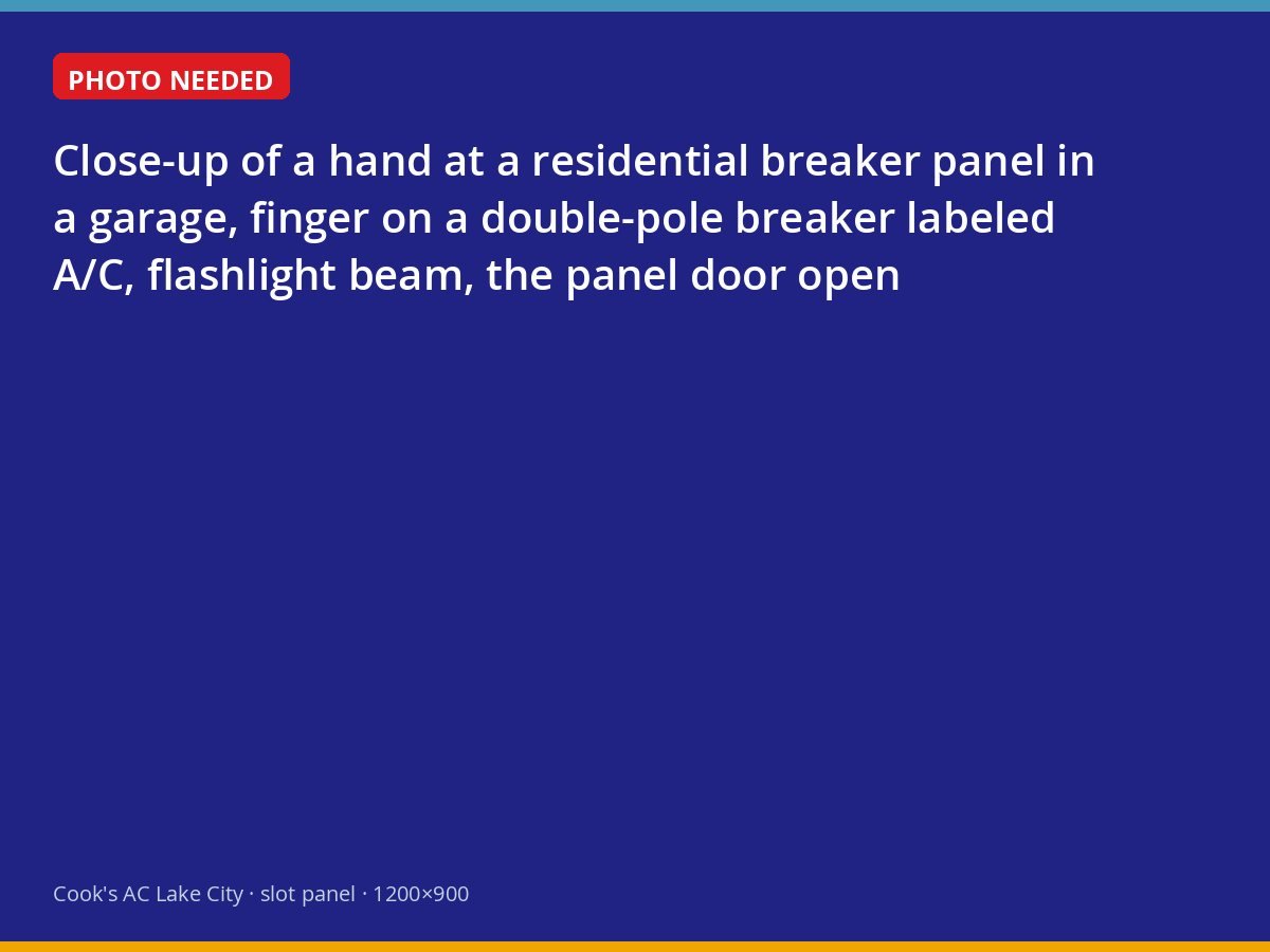 Homeowner checking the air conditioner breaker in a garage electrical panel